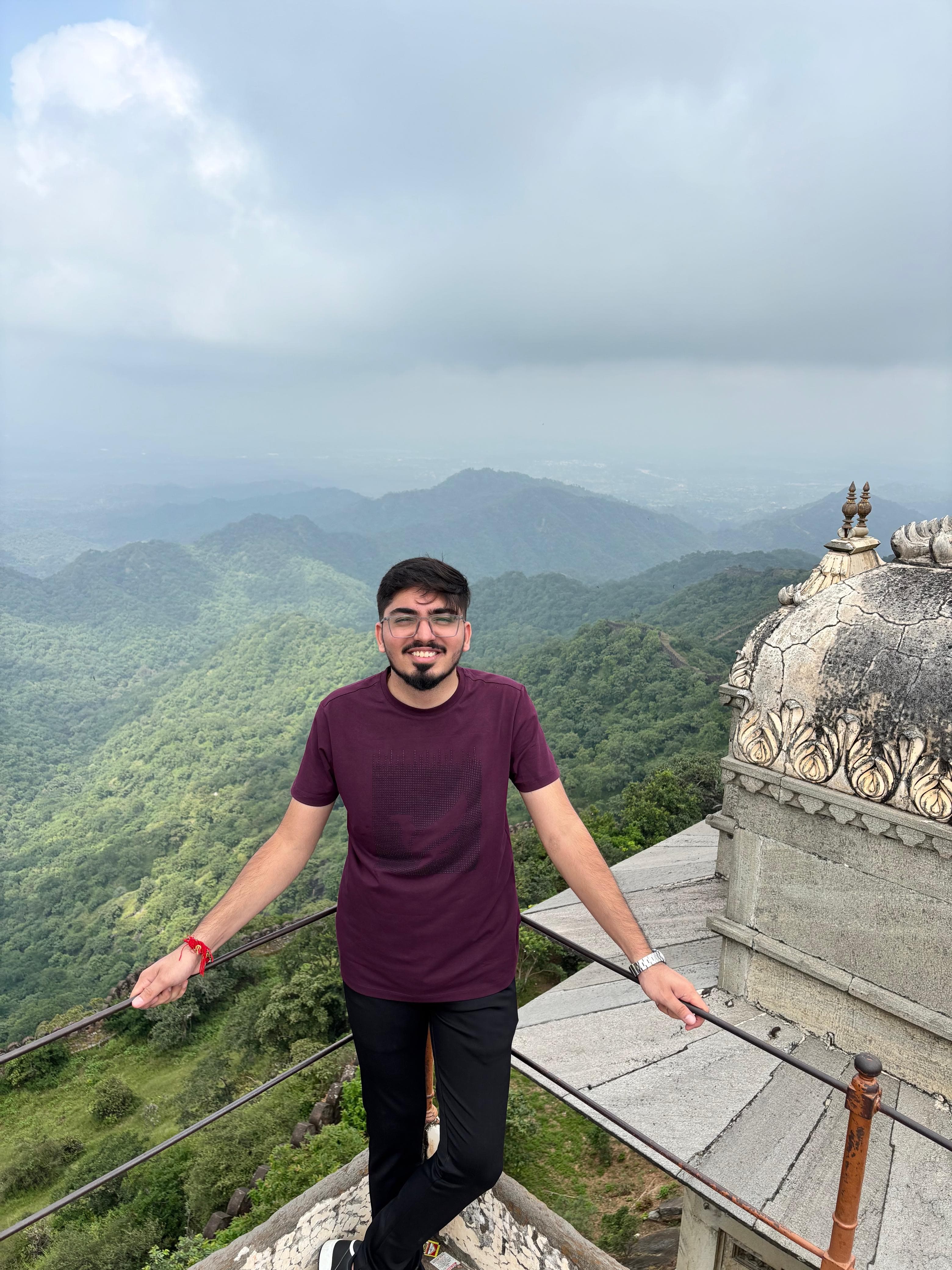 Utsav Somaiya standing at a mountain viewpoint